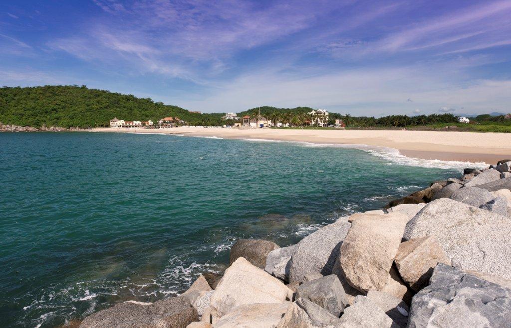 Chahue beach in Huatulco with crystal clear blue waters, white sand and sunshine.